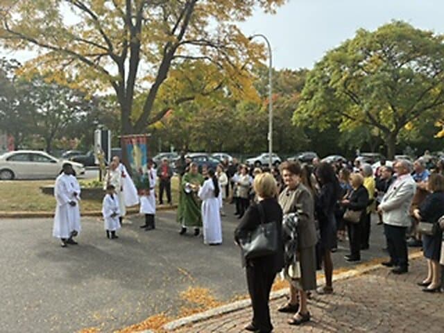 Blessing of the new cross outside Église Sainte-Angèle