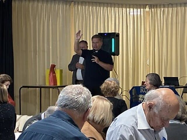 A speaker addressing guests at the dinner